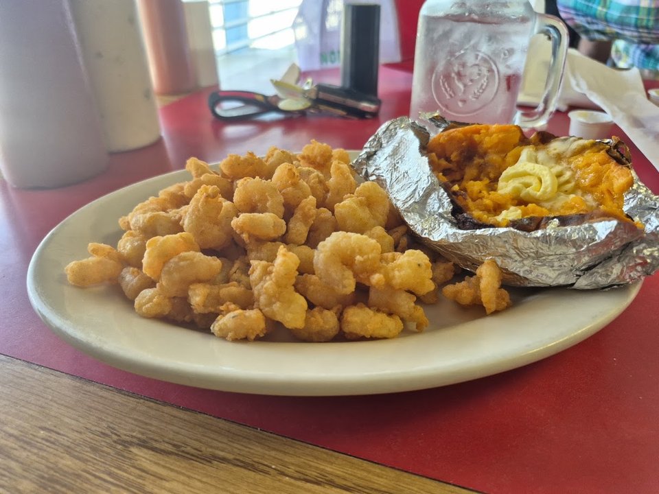 A hearty seafood dinner with sides and lemon.
